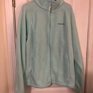 Fleece jacket  has stand up collar. Elastic in sleeve. Zip pockets